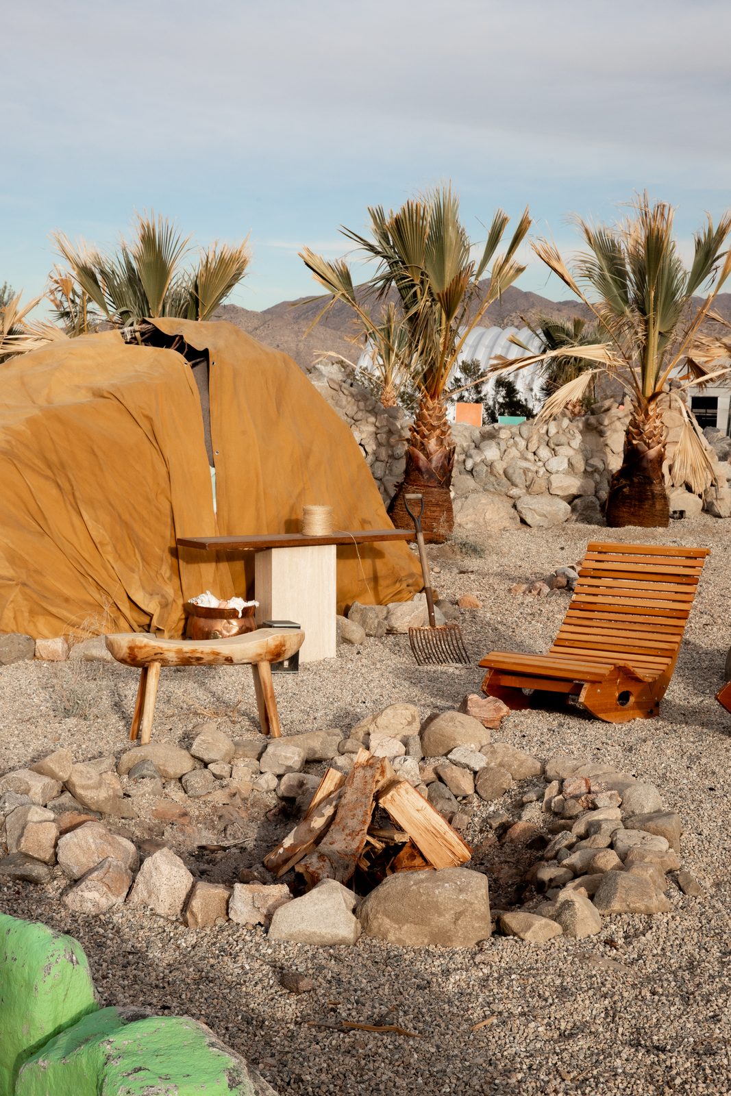 Chairs pulled around the fire pit among the palms with the dome behind