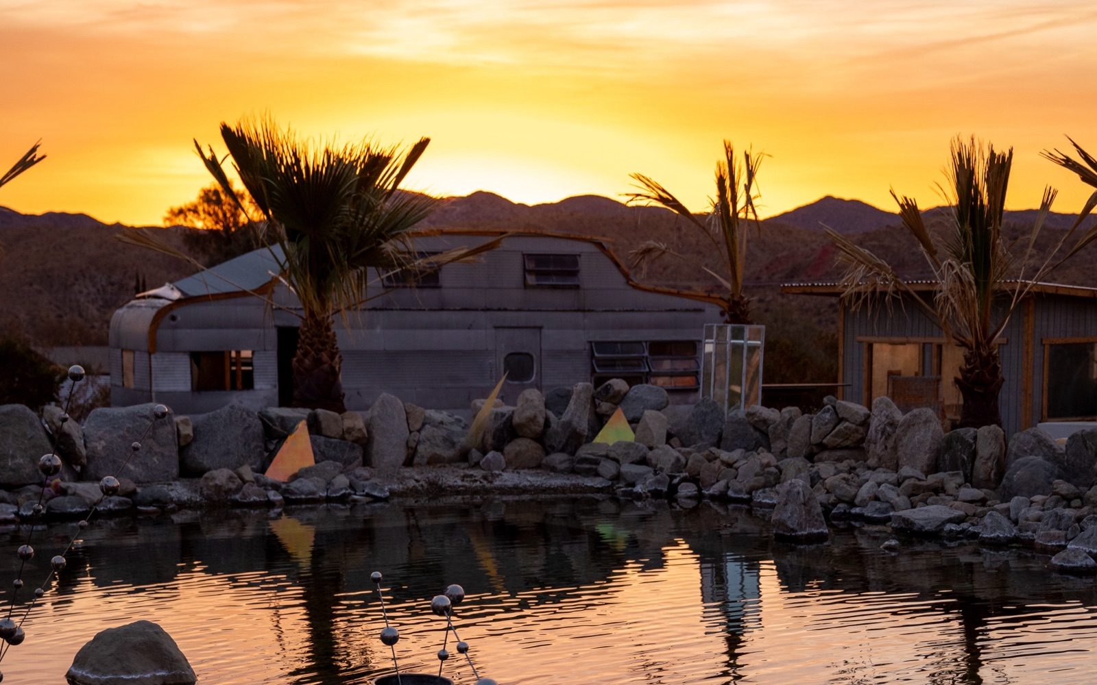 The natural pool glowing at dusk as the desert cools